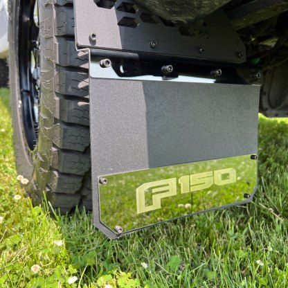 15-25 Ford F-150 Putco Mud Skins, Ford Licensed Mud Flaps - Featuring a laser-etched "F150" logo on their sleek black platinum stainless steel surface.